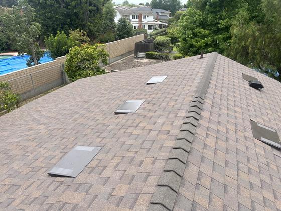 Completed dimensional shingle re-roof with new ridge cap and attic vents
