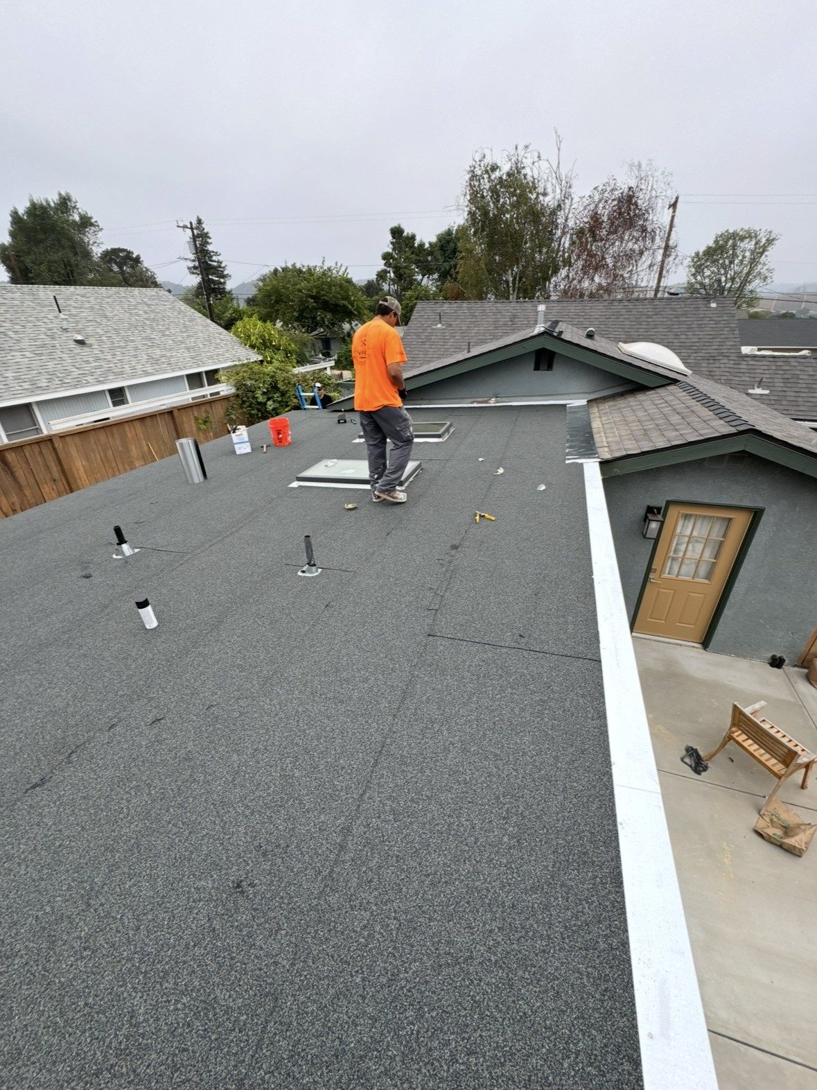 NRG Roofing crew member on a completed torch-down flat roof in Ventura County