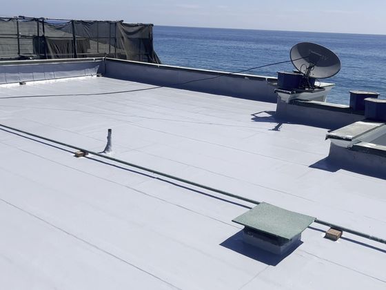 Completed silicone-coated flat roof with ocean view, Malibu, by NRG Roofing