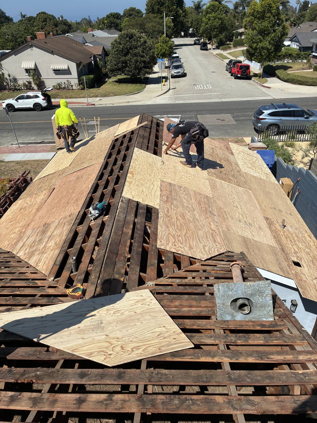 NRG Roofing crew installing new plywood roof decking during a re-roof in Ventura