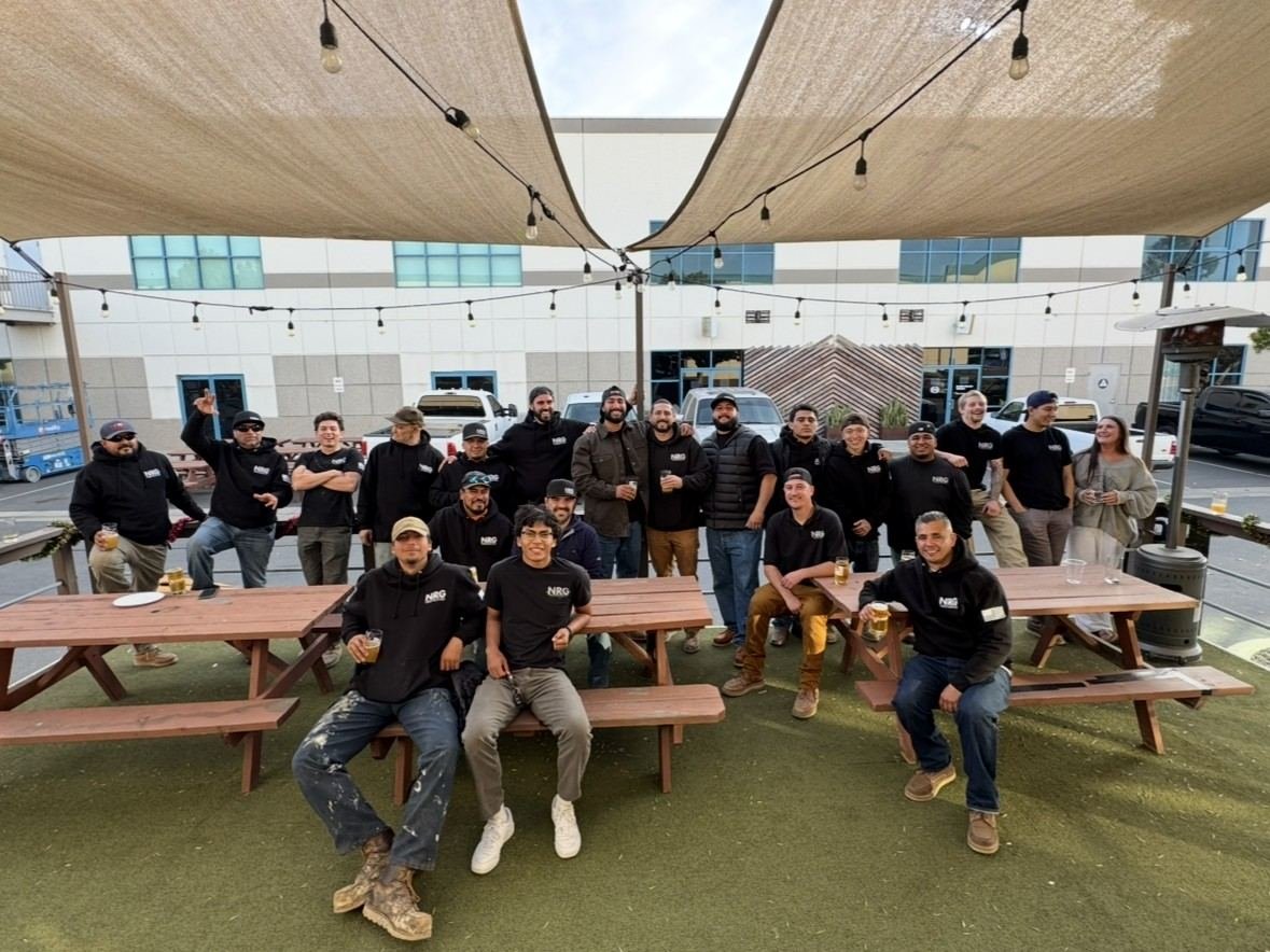 The NRG team gathered around picnic benches after work — the crews behind every NRG roof