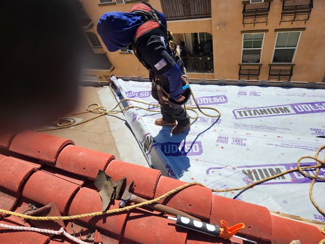 NRG Roofing crew on new Titanium UDL50 underlayment above a condo unit, Oxnard HOA