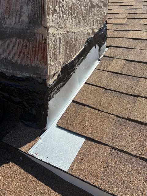 Custom 316 stainless steel chimney cricket and corner flashing on a new shingle roof in Oxnard by NRG Roofing