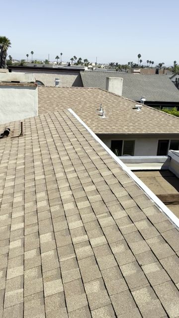 Finished Oxnard partial re-roof: new shingle field, stainless parapet cap, chimney cricket and skylight, by NRG Roofing