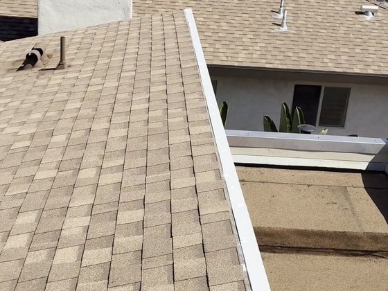 Finished 316 stainless steel parapet wall cap and edge metal where the shingle roof meets the torch-down section, Oxnard partial re-roof by NRG Roofing