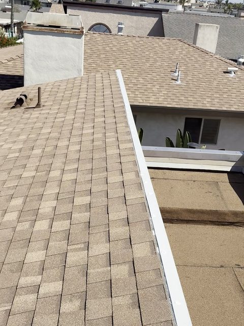 Finished 316 stainless steel parapet wall cap and edge metal where the shingle roof meets the torch-down section, Oxnard partial re-roof by NRG Roofing
