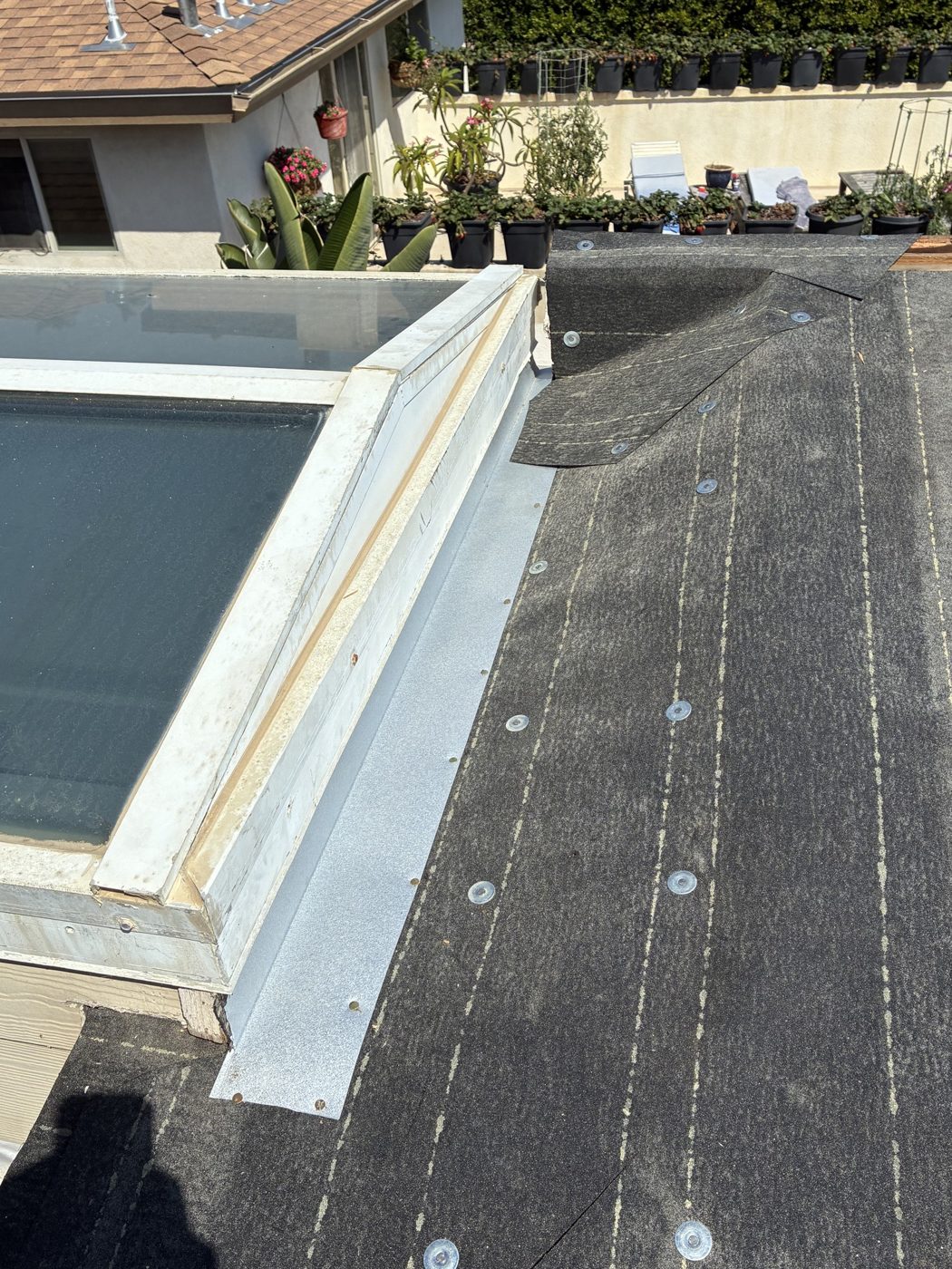 New skylight curb flashing over base sheet on a torch-down flat section, Oxnard, NRG Roofing
