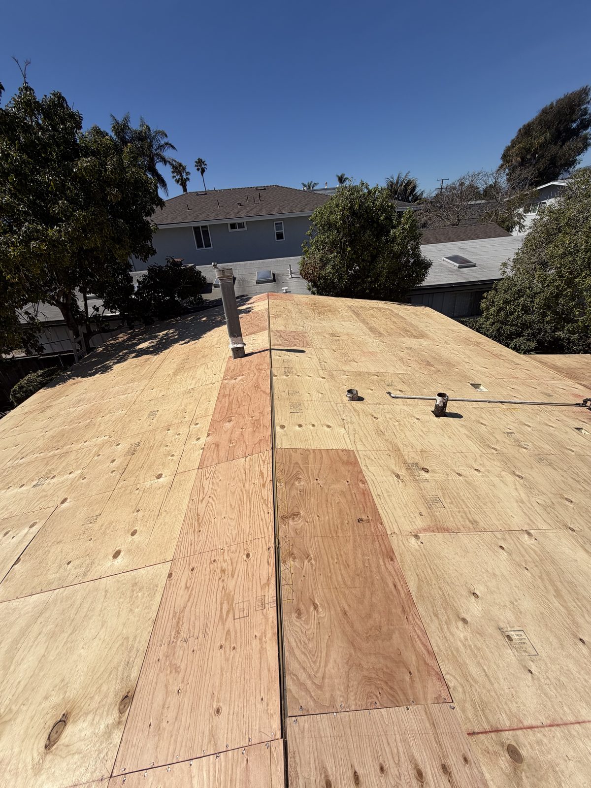 New plywood roof decking installed during a re-sheet by NRG Roofing in Ventura County