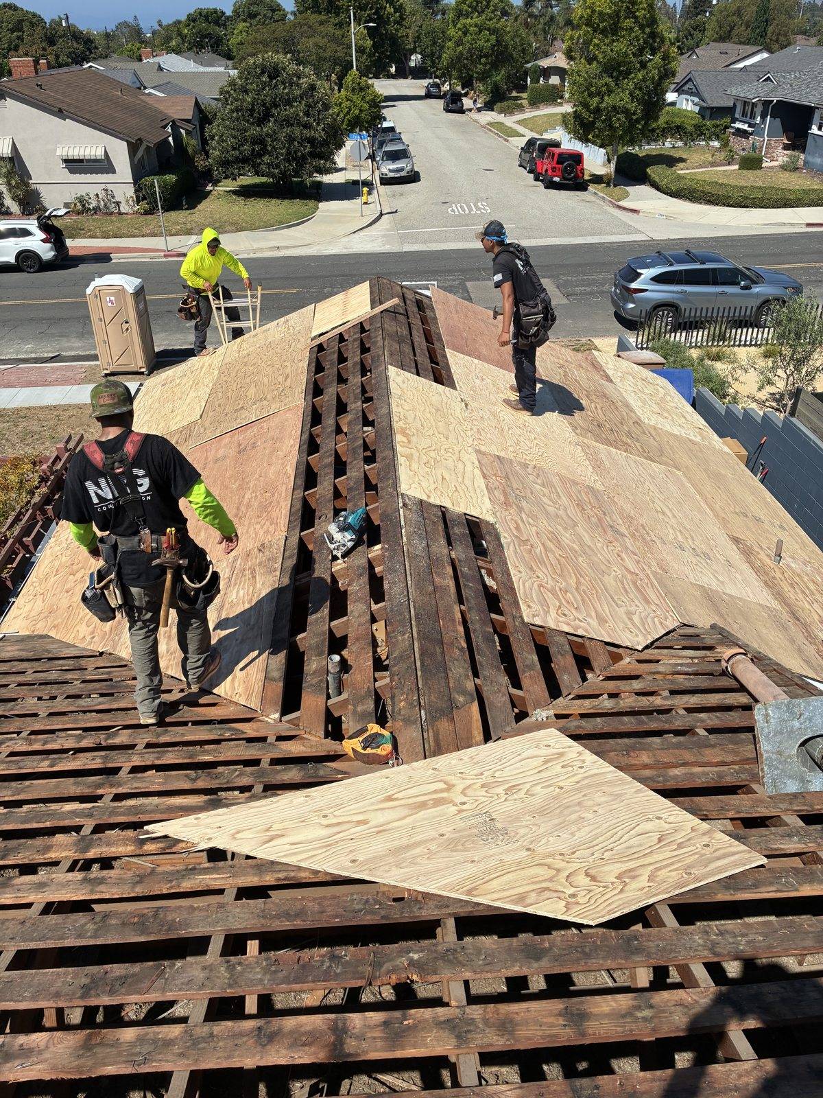 NRG Roofing crew installing new plywood roof deck over original skip sheathing in Ventura