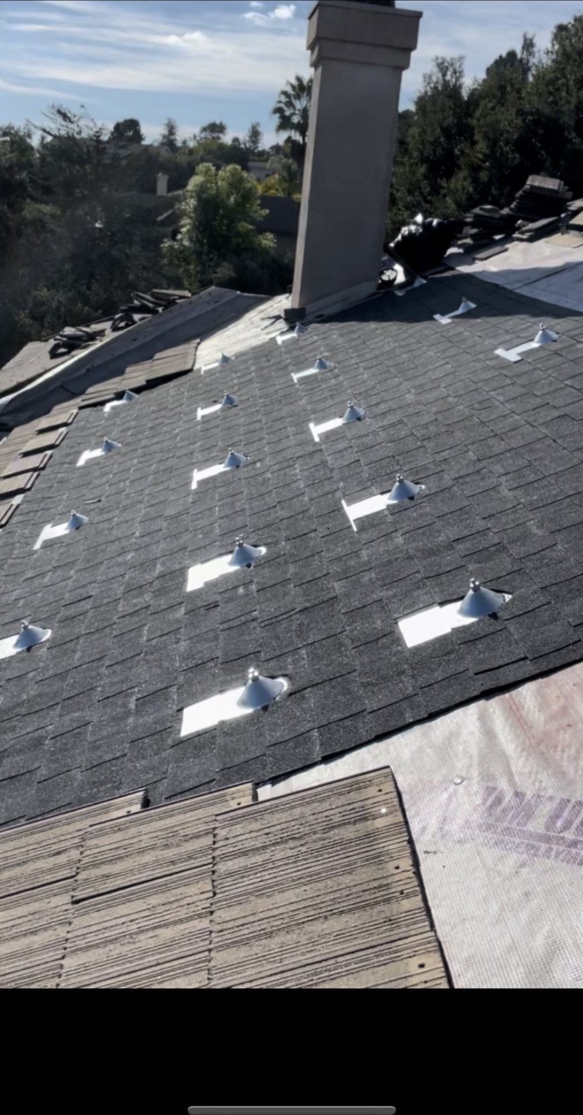 Asphalt shingle re-roof with solar mount flashings by NRG Roofing in Ventura County