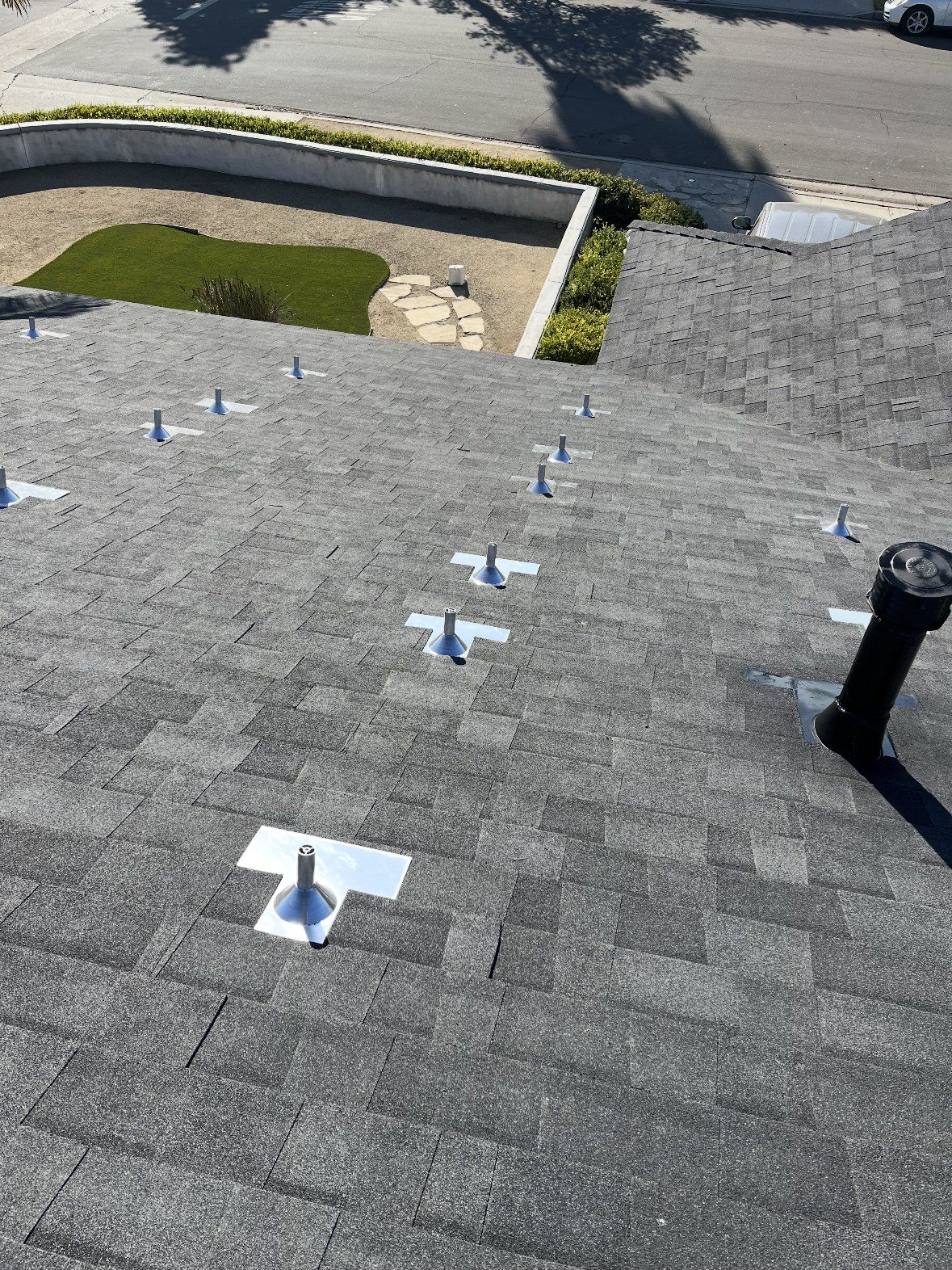 Charcoal asphalt shingle roof with new pipe flashings installed by NRG Roofing in Ventura County