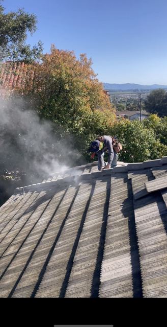 NRG Roofing crew repairing a tile roof on a hillside home in Ventura County