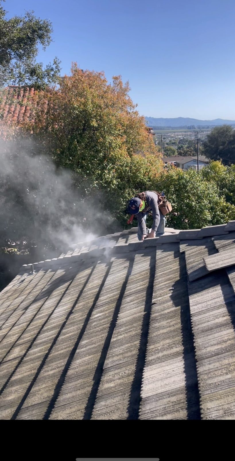NRG Roofing crew repairing a tile roof on a hillside home in Ventura County