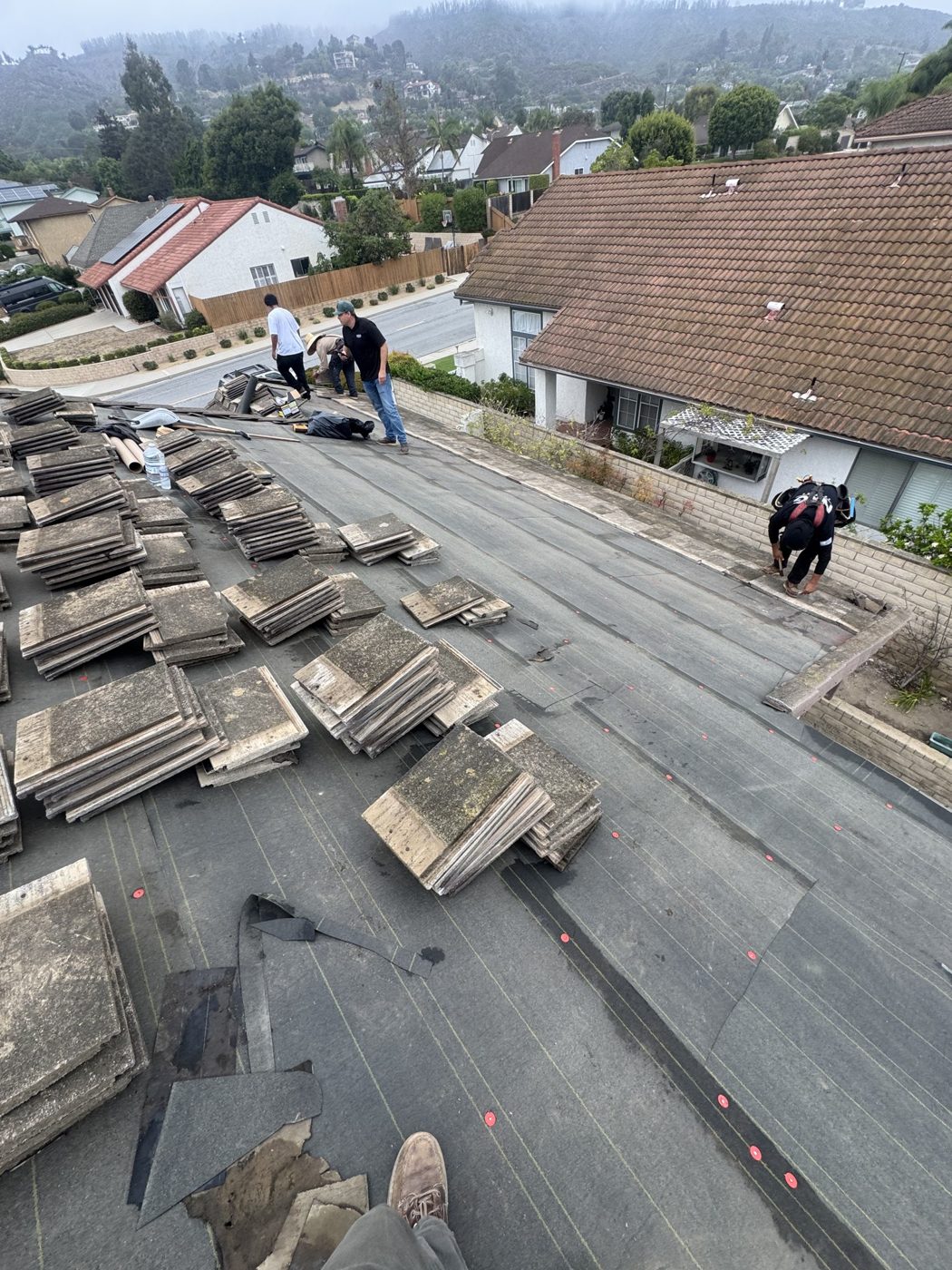 Tile roof facet papered with new underlayment, original tile staged for re-set, Ventura, NRG Roofing