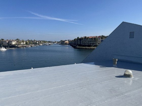 Completed white flat roof on a commercial building overlooking the harbor in Ventura County