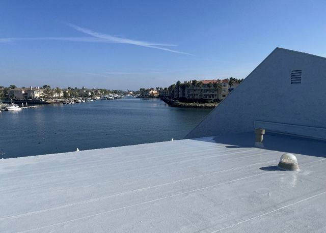 White flat roof completed by NRG Roofing on a harbor-front building in Ventura County